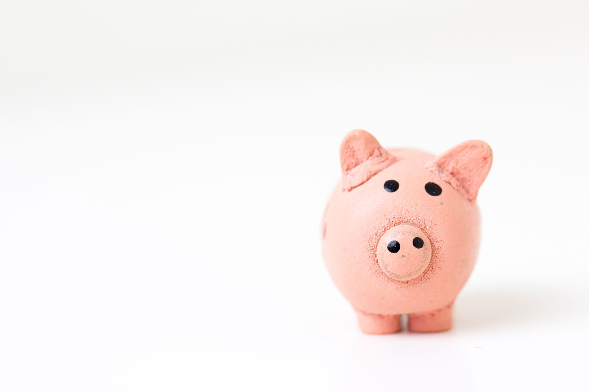 Piggy bank being used to teach kids about money and savings